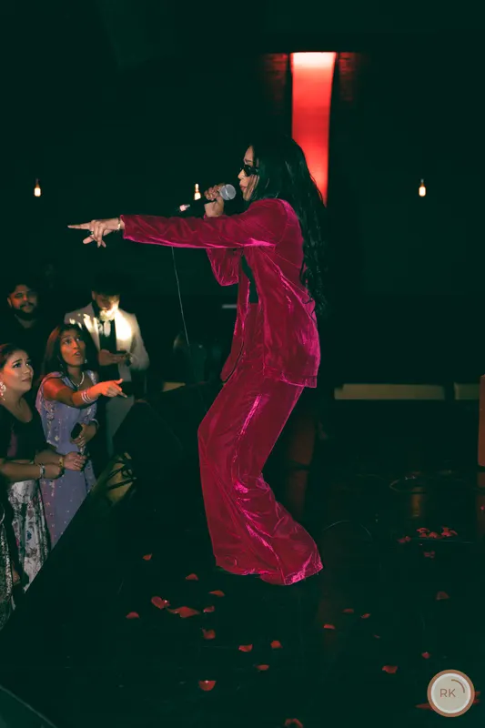 Navz-47 on stage in a red two-piece